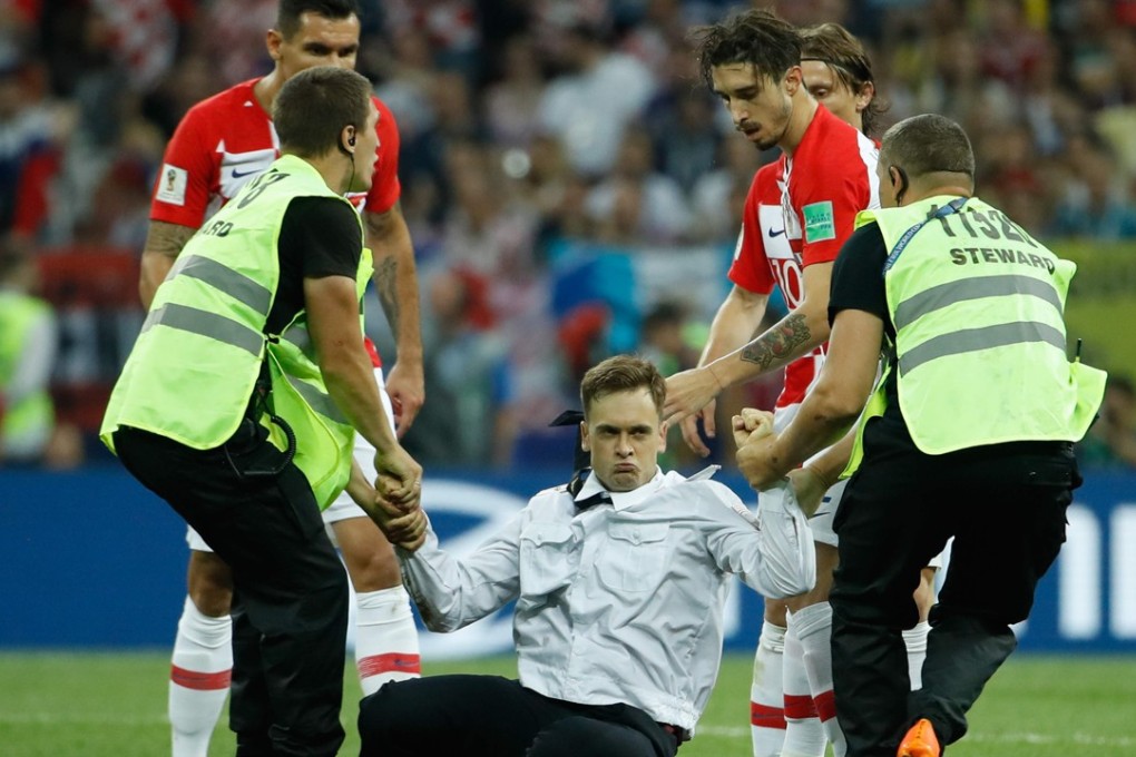 Stewards remove member of the Pussy Riot punk group Pyotr Verzilov during the Russia 2018 World Cup final football match between France and Croatia. Photo: AFP