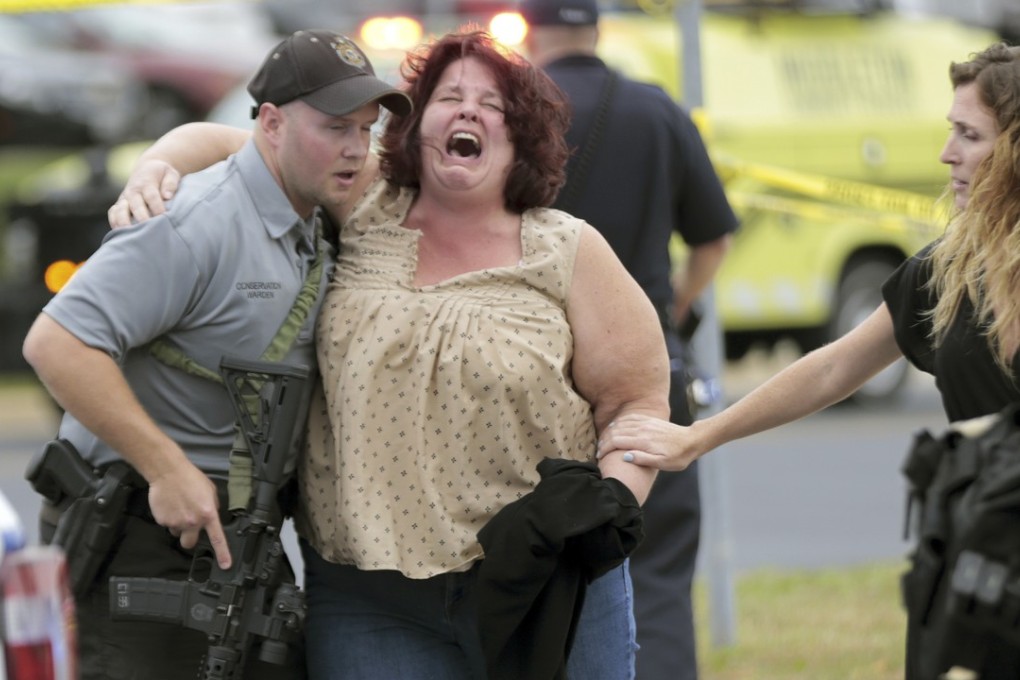 A woman is escorted from the scene of a shooting at a software company in Middleton, Wisconsin on Wednesday. Photo: AP