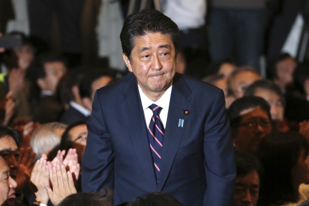Liberal Democratic Party President Shinzo Abe receives applause from the LDP lawmakers soon after winning a third term as LDP leader, paving the way for him to serve as prime minister for up to three more years. Photo: AP