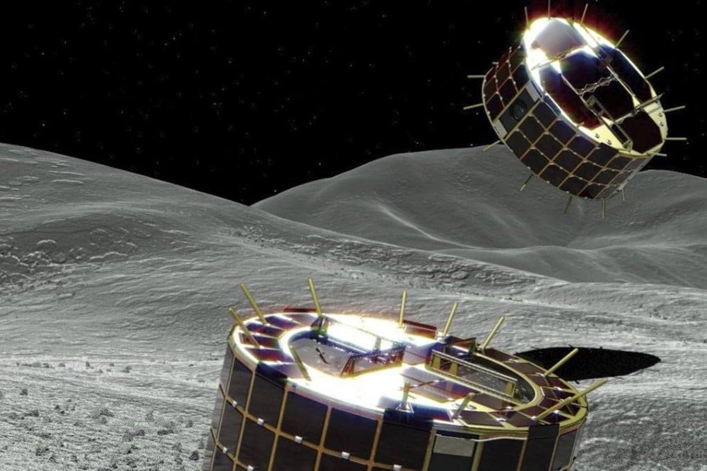 A JAXA computer generated image of the two biscuit-tin-shaped solar-powered rovers on the surface of the asteroid. Photo: AP
