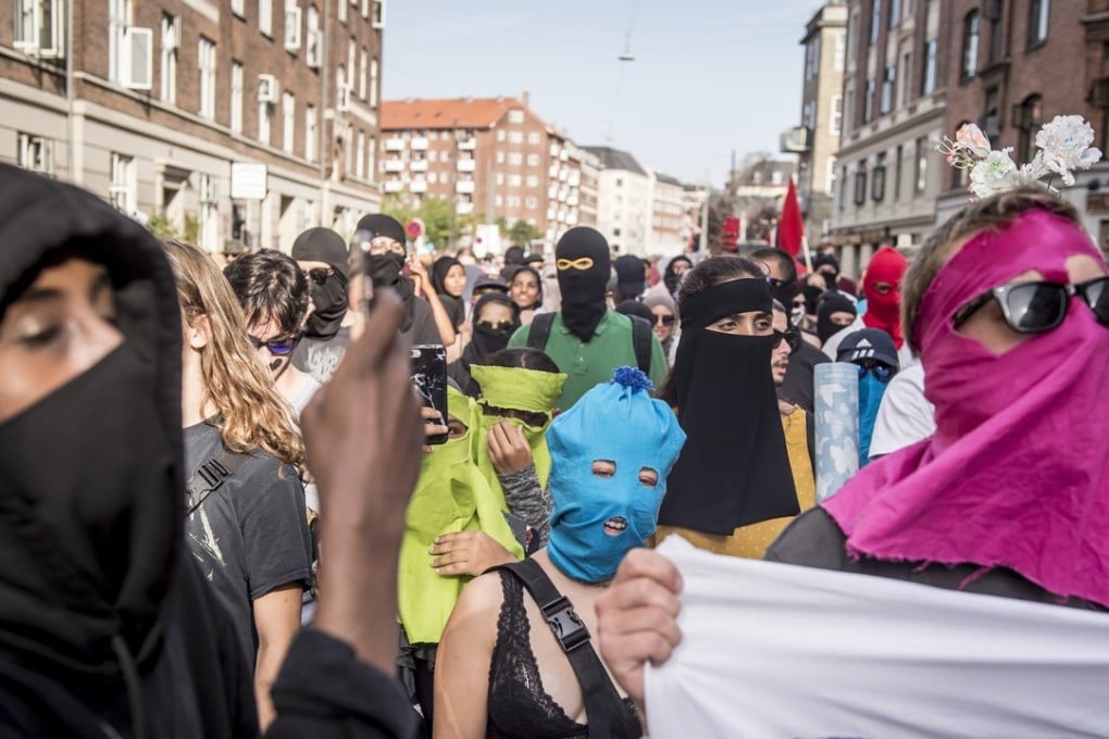 People demonstrate in Copenhagen, Denmark, on August 1, 2018, as a new ban on garments covering the face was implemented. A Swiss canton is now planning to vote on a similar measure. Photo: AP