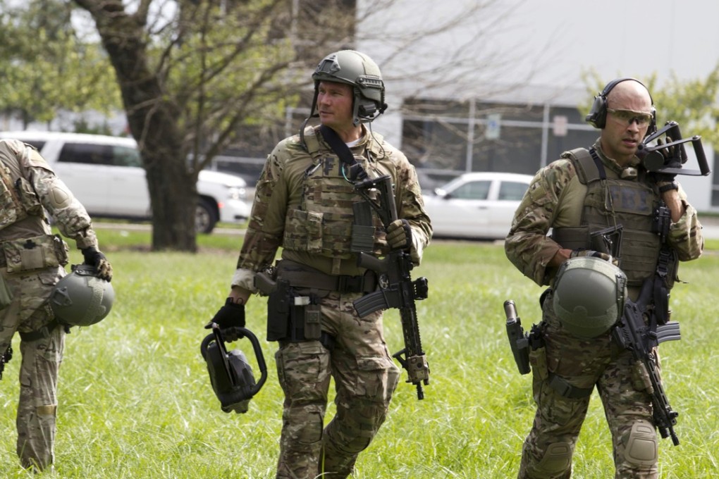 FBI agents walk at the industrial business park where temp worker Snochia Moseley shot several people in Harford County, Maryland, on Thursday. Photo: AP