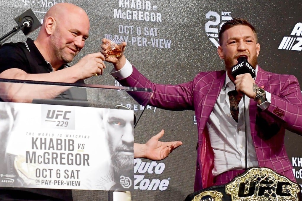 Conor McGregor shares his Irish whiskey with UFC president Dana White during the UFC 229 press conference at Radio City Music Hall in New York City. Photo: AFP