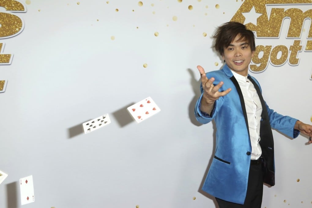 America’s Got Talen winner magician Shin Lim throw his cards as he arrives at the Dolby Theatre on Wednesday in Los Angeles. Photo: AP
