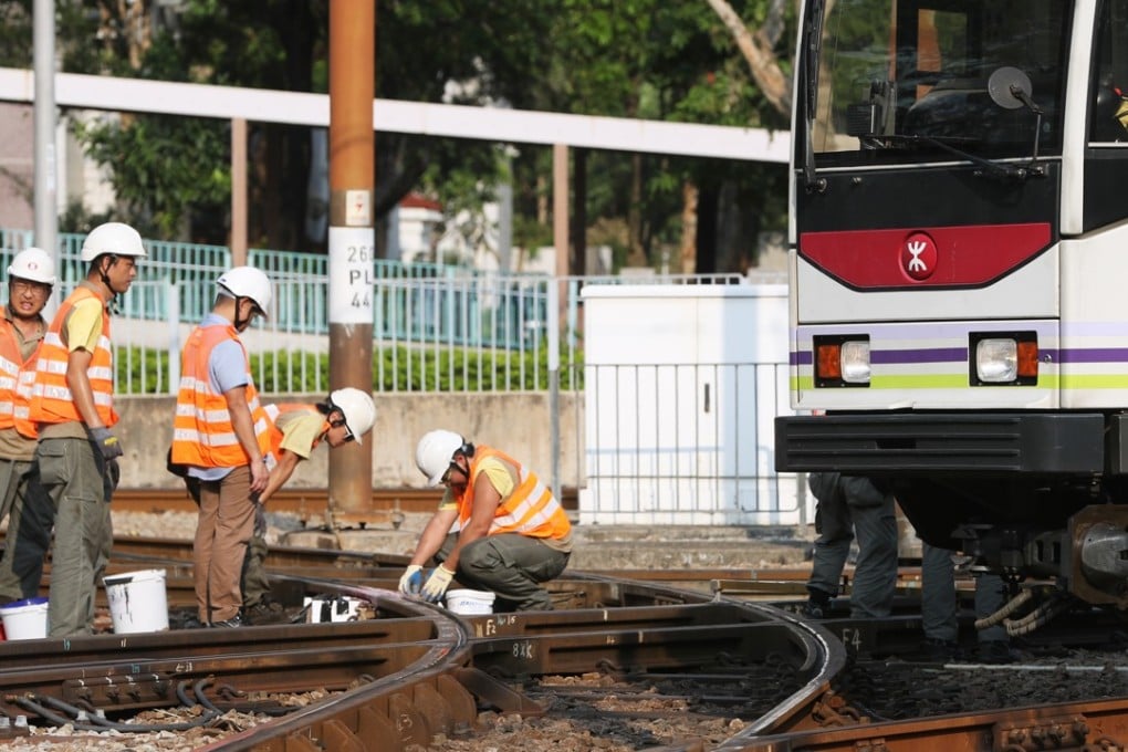 Workers near the MTR’s light rail stop Goodview Garden in Tuen Mun fixing the track where a 50-cm long crack was discovered before noon on Thursday. Photo: Edward Wong