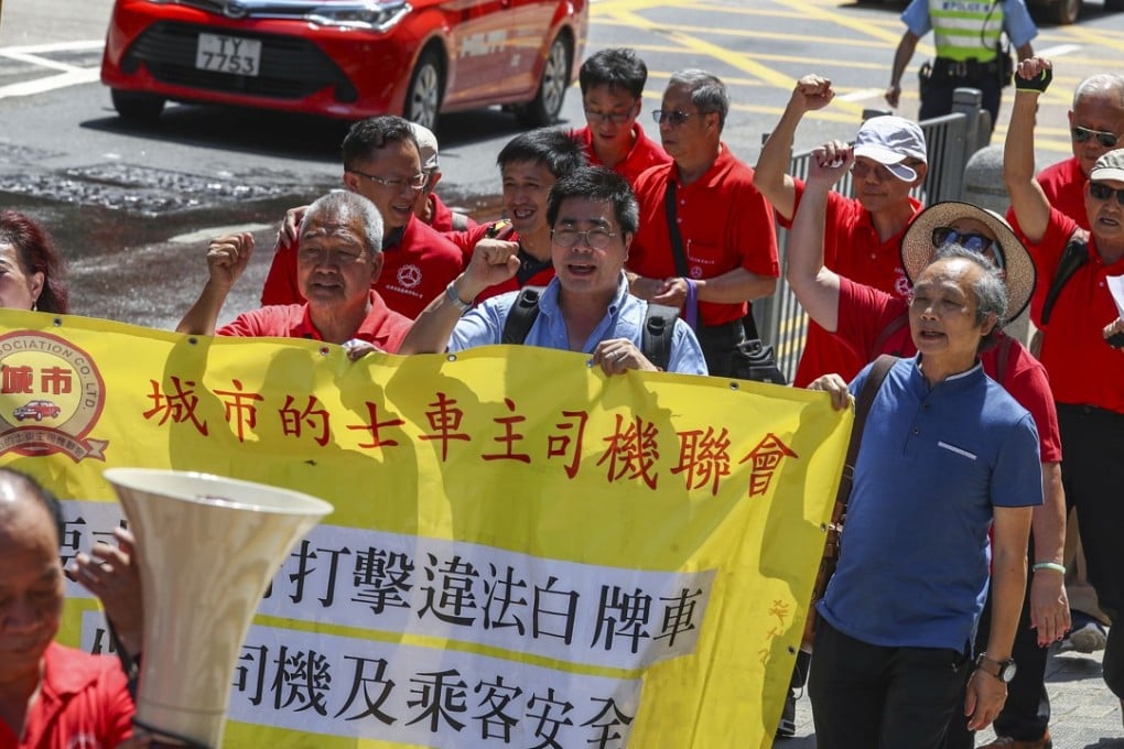 Urban and New Territories taxi owners and drivers march to the government headquarters to protest against “unlicensed drivers” and a proposed penalty point system for cabbies, in Wan Chai on May 23. Photo: Nora Tam