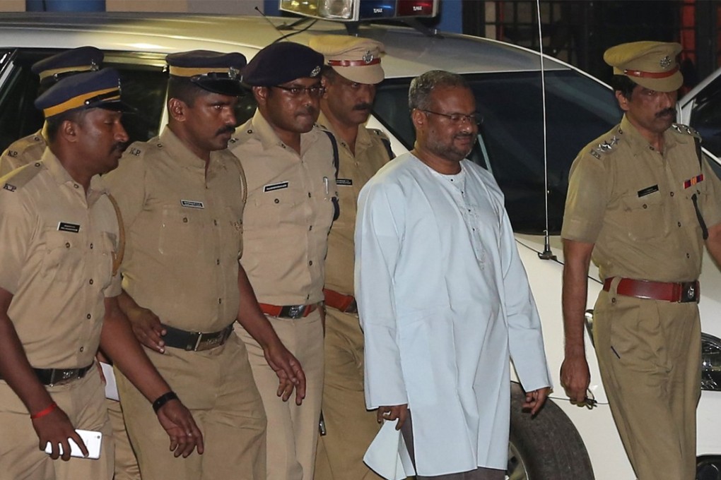 Bishop Franco Mulakkal, second from right, is escorted by police on the outskirts of Kochi in the southern state of Kerala, India on Friday. Photo: Reuters