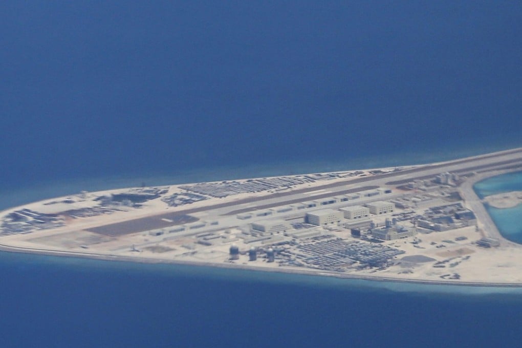 A Chinese airstrip on a man-made reef in the Spratly chain of islands in the South China Sea is seen from a Philippine air force transport plane in 2017. Photo: AP