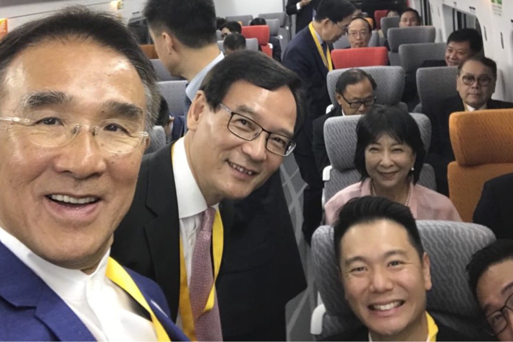 Lawmakers Michael Tien (left) and Tony Tse (second from left) pose for a selfie on the first cross-border train. Photo: Facebook