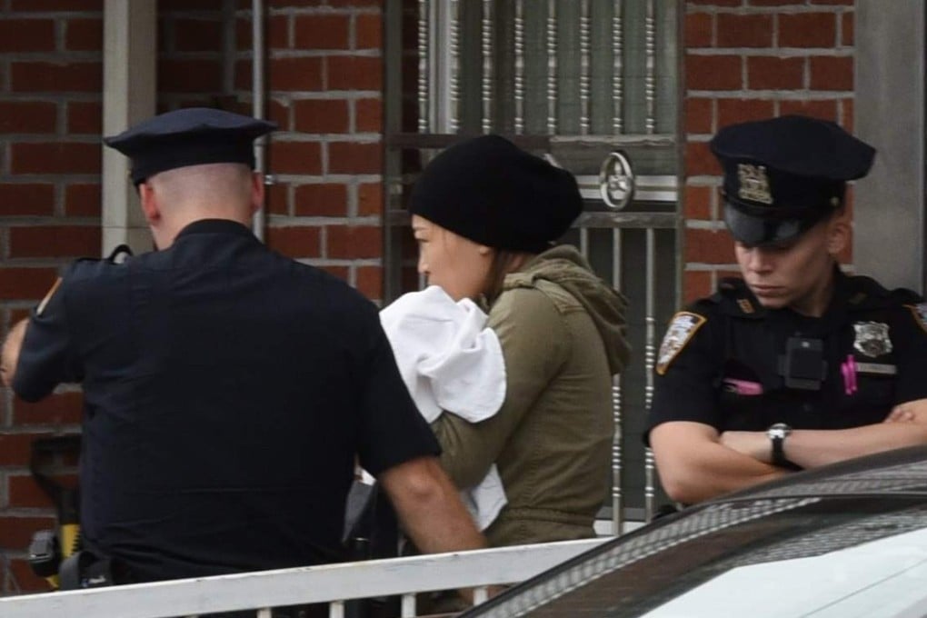 Police escort an unidentified woman and her baby from the centre after the attack. Photo: AFP