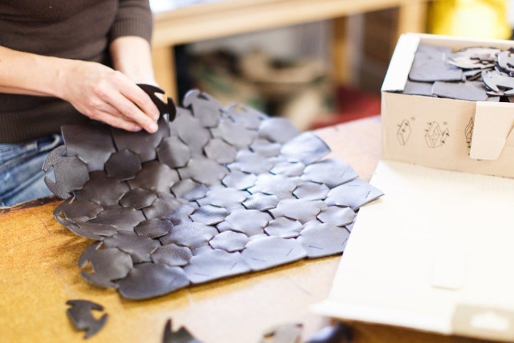 Recycled leather pieces being sewn into a bag at sustainable luxury fashion brand Elvis and Kresse.