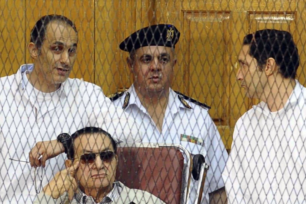 A motion by former Egyptian President Hosni Mubarak, seated, and his two sons Gamal Mubarak, left, and Alaa Mubarak, right, to overturn their conviction on corruption charges has been rejected. Photo: AP