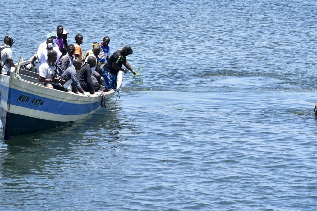 A rescue diver, right, searches in the water for bodies. Photo: AP