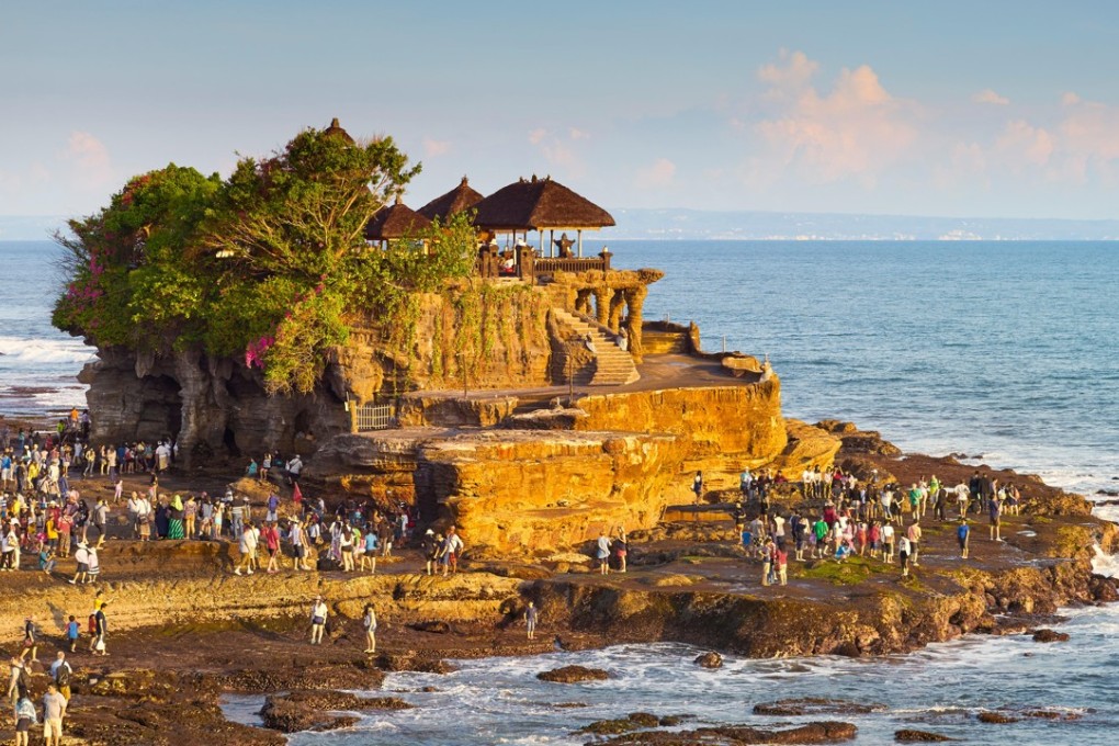 Tourists visit the Tanah Lot Temple in Bali. The island’s deputy governor has lamented a decline in the quality of visitors to the Hindu island in Indonesia. Photo: Alamy
