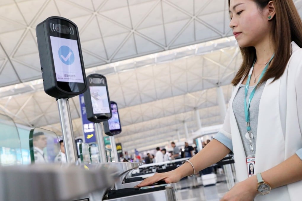 A member of staff demonstrates using an e-security gate at Hong Kong International Airport. Photo: K.Y. Cheng