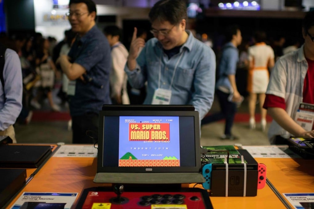 Visitors enjoy old video games at the Tokyo Game Show. Photo: AFP