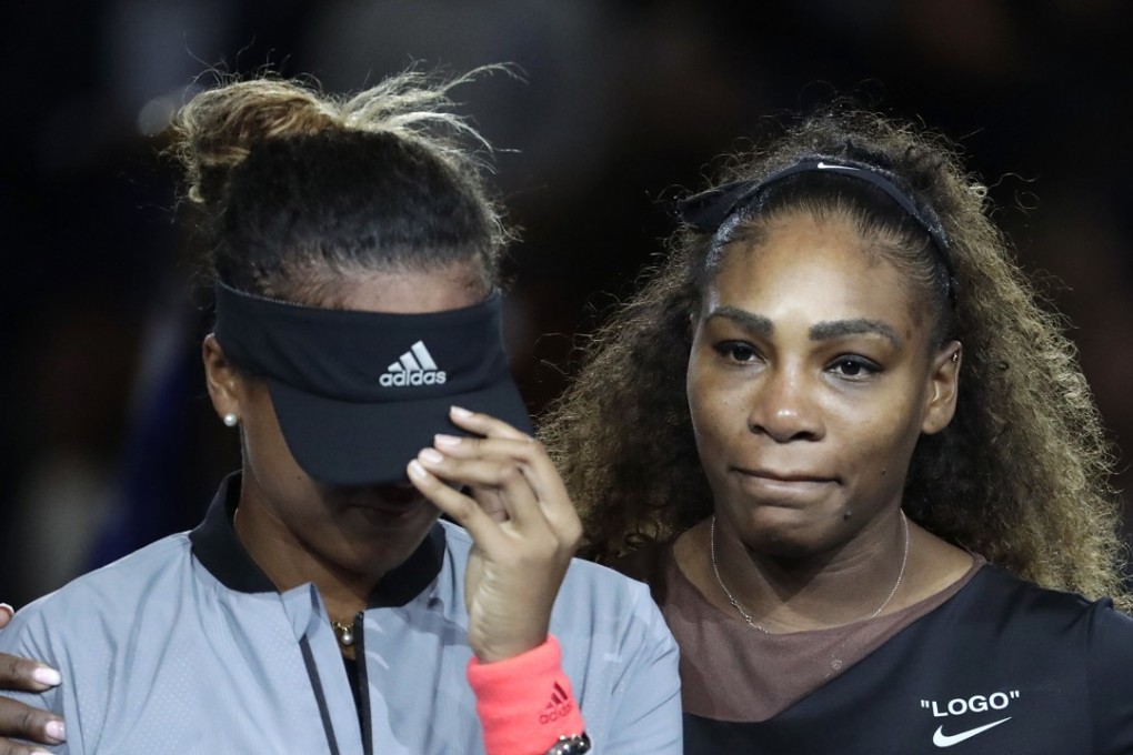 An upset Naomi Osaka of Japan pulls down her visor over her eyes, as the crowd boos during the trophy ceremony after the women’s singles final of the US Open, in New York on September 8. Osaka beat Serena Williams 6-2, 6-4. Photo: AP