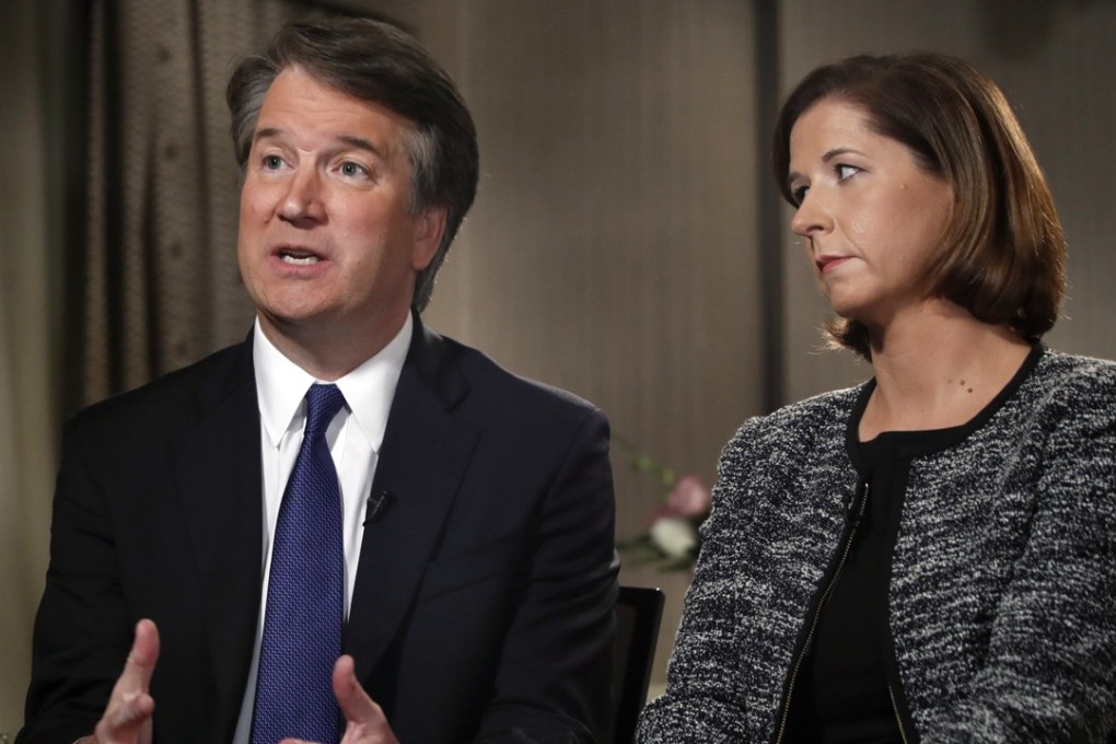 Brett Kavanaugh, with his wife Ashley Estes Kavanaugh, answers questions during a FOX News interview. Photo: AP