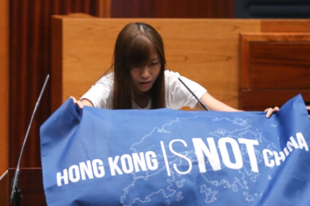 Yau Wai-ching displays a banner reading “Hong Kong is not China”, during the oath-taking session for the city’s sixth Legislative Council, on October 12, 2016. Photo: Sam Tsang