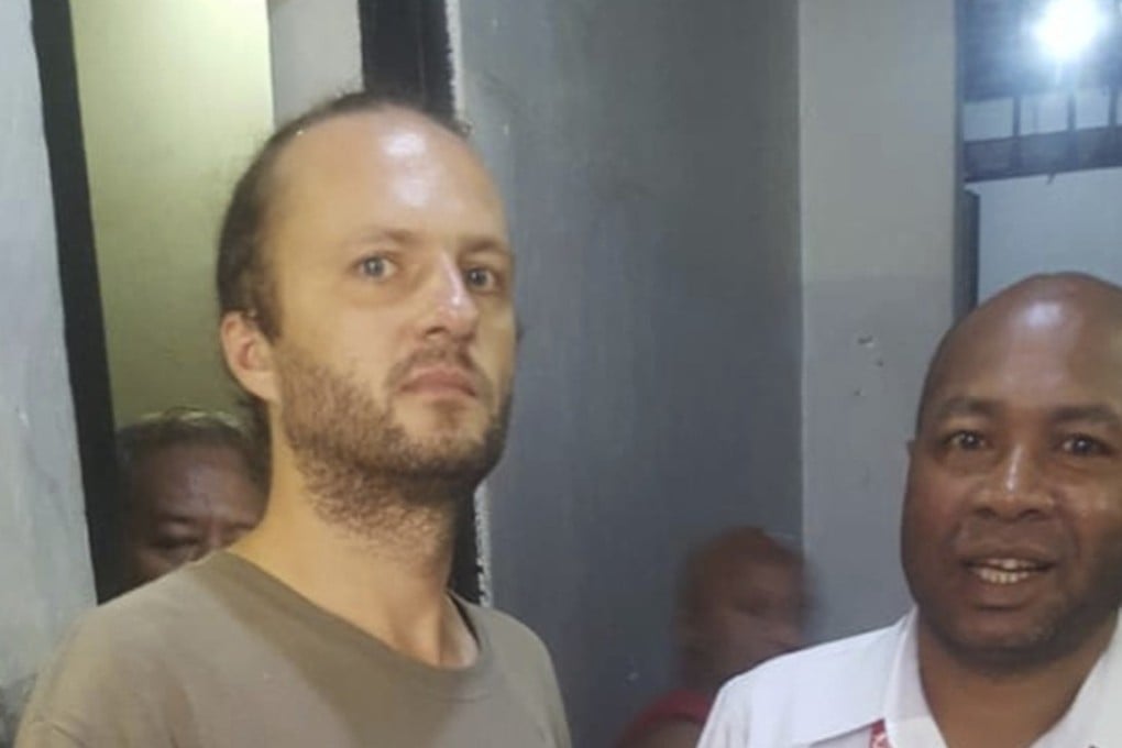 Polish national Jakub Skrzypski talks with the head of Papua Representative Office of the National Human Rights Commission Frits Ramandey at his detention house in Jayapura, Papua province, Indonesia. Photo: AP