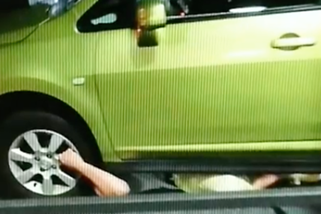 A still of a video showing Japan rugby prop Takuma Asahara trapped under a car. Photo: Facebook/Rugby News Japan