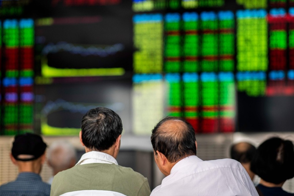 Investors monitor stock prices at a securities company in Shanghai. Global index compiler MSCI is looking to increase the weighting of Chinese stocks in its indexes. Photo: AFP