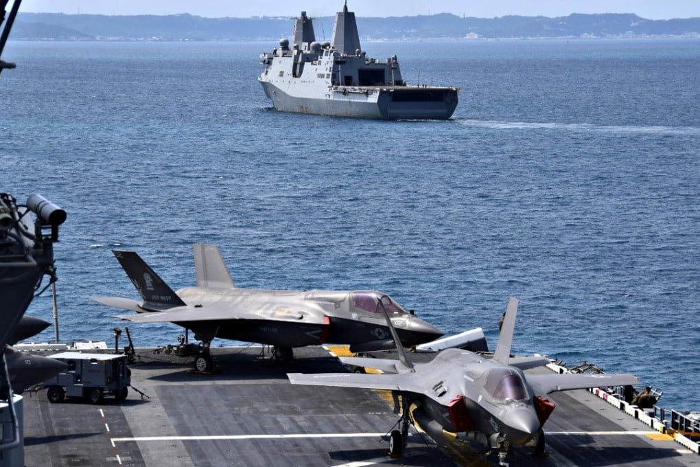 The USS Green Bay passes the USS Wasp as it leaves Okinawa. Beijing rejected a request for the USS Wasp to visit Hong Kong next month. Photo: US Navy