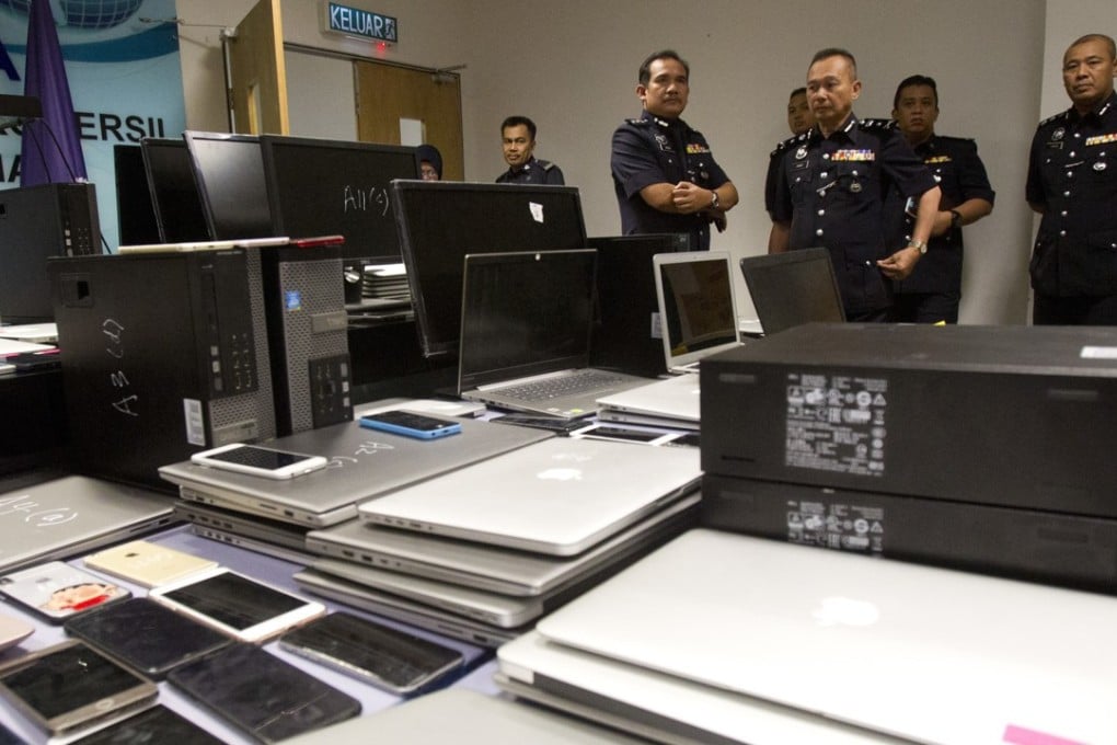 Malaysian police arrested 93 Chinese and six locals in a raid on a suspected telephone scam operation in Kuala Lumpur on Frday. Photo: AP