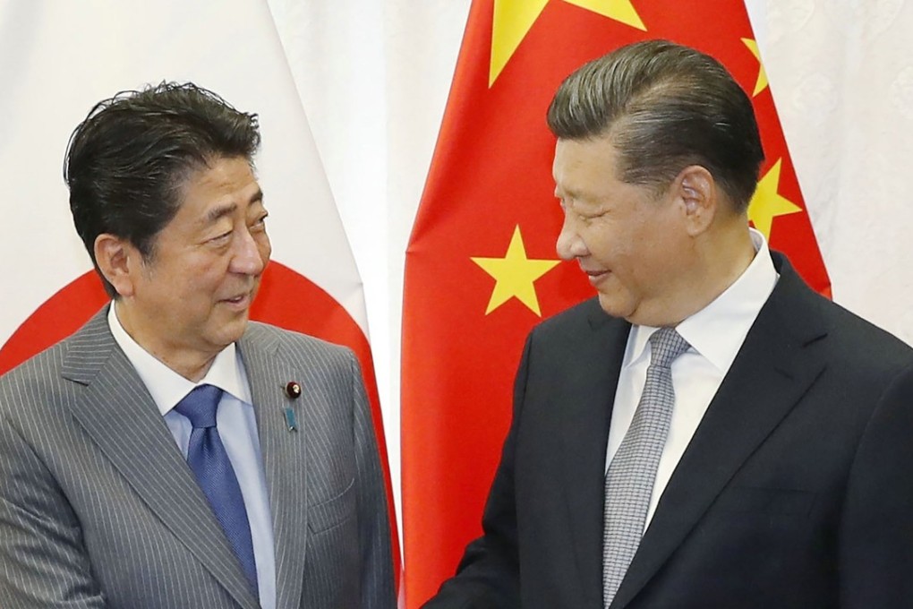 Japan's Prime Minister Shinzo Abe (left) shakes hands with China's President Xi Jinping prior to their bilateral meeting in Vladivostok on September 12, 2018. Photo: Jiji Press