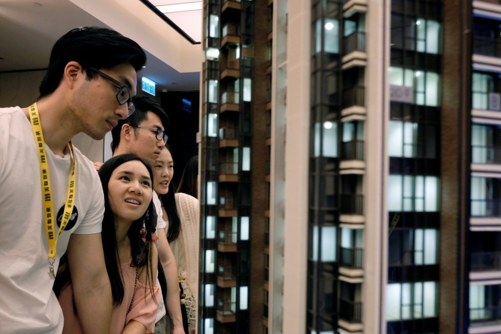Prospective buyers assess a model of the LP6 property development by Nan Fung Group at a sales centre in Hong Kong. Photo: Reuters