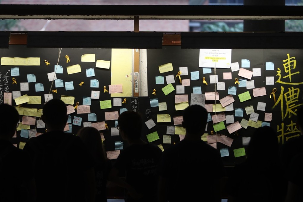 Students gather at the bulletin board of Polytechnic University on Friday evening. Photo: Winson Wong