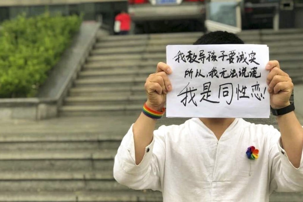Kindergarten teacher Ming Jue holds up a sign that reads, “I teach children to be honest, so I cannot lie. I am gay!” Photo: Ming Jue