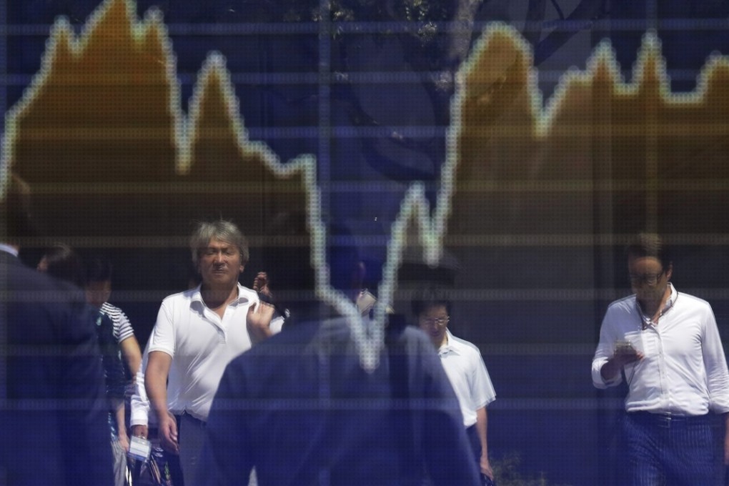Reflections off an electronic board outside a securities firm in Tokyo on August 30, 2018. Photo: Bloomberg