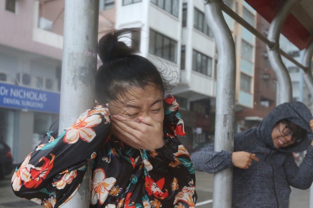 Storm chasers brave the heavy rain and strong wind in Kennedy Town when the No 10 typhoon signal was in force on September 16. Photo: Xiaomei Chen