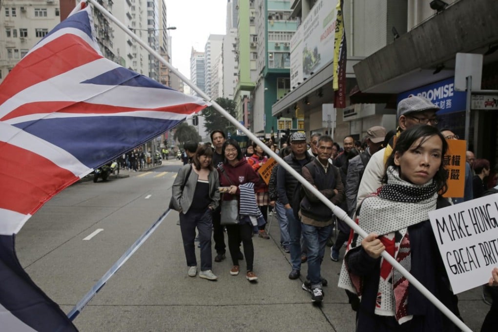 A protester calling for a defence of the Hong Kong Basic Law and “one country, two systems” holds a British flag during a rally on January 1. Photo: AP