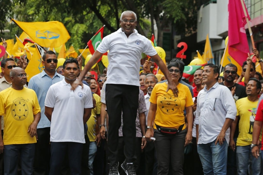 Opposition presidential candidate Ibrahim Mohamed Solih jumps as he walks in a street march with supporters on September 22, 2018. Photo: AP