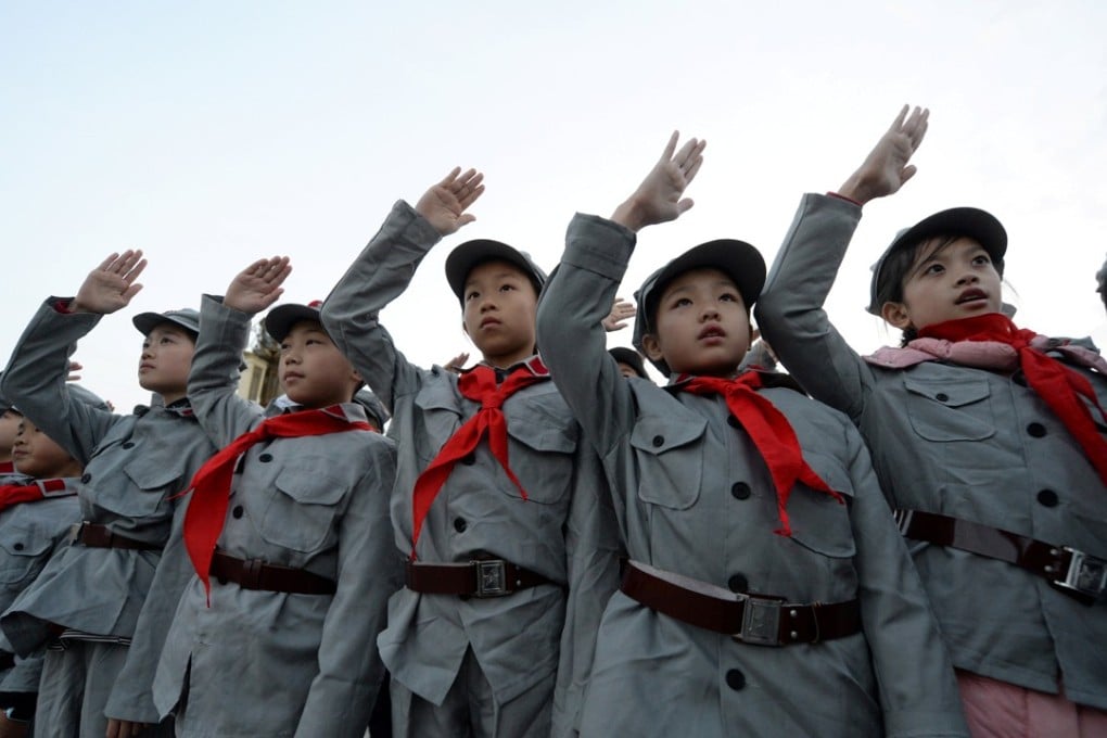Primary school students dressed in replica red army uniforms and the Young Pioneer scarf at a ceremony in Beijing. Photo: Reuters