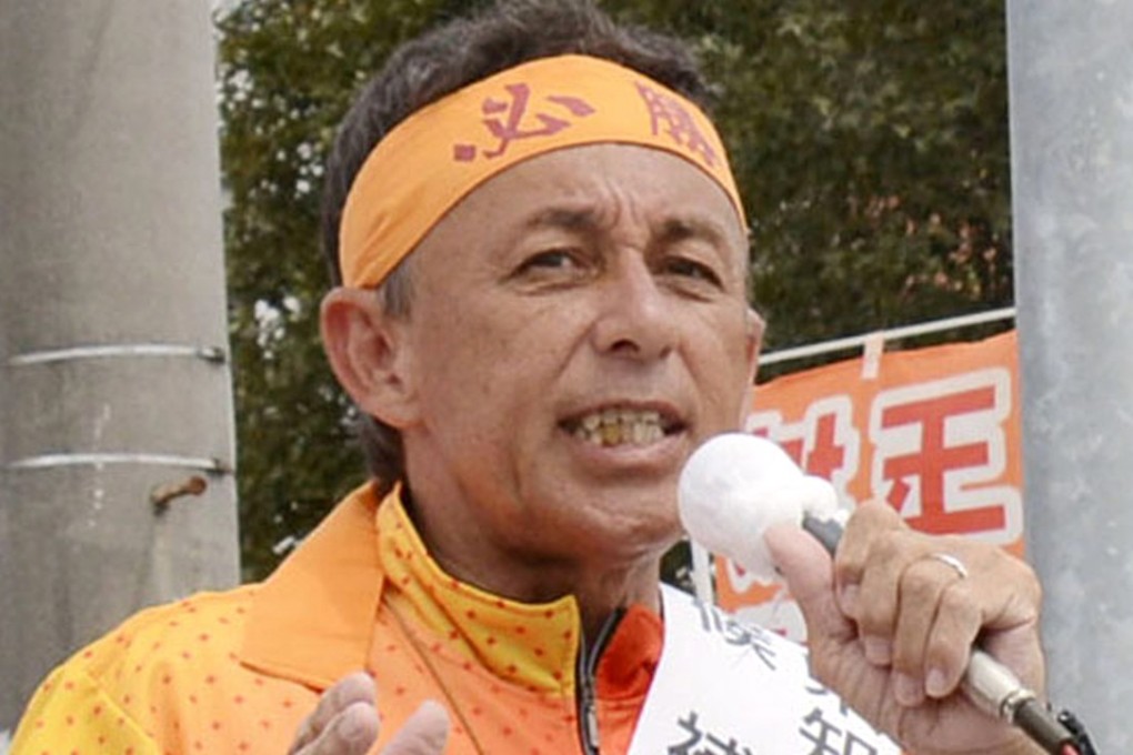 Denny Tamaki delivers a speech during his election campaign for Okinawa governor. Photo: AP