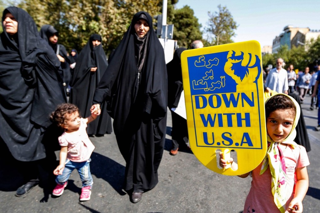 An Iranian girl raises an anti-US sign as she marches with others during a demonstration following weekly Muslim Friday prayers in the capital Tehran. Photo: AFP