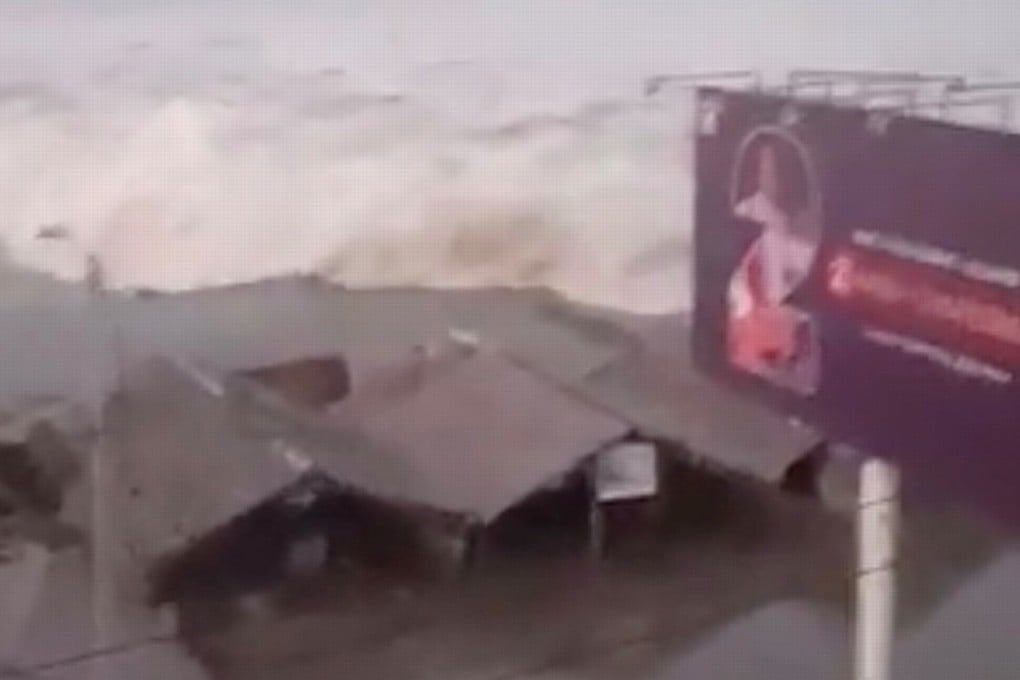 A screen grab of the tsunami wave hitting the shore in Palu. Photo: Reuters