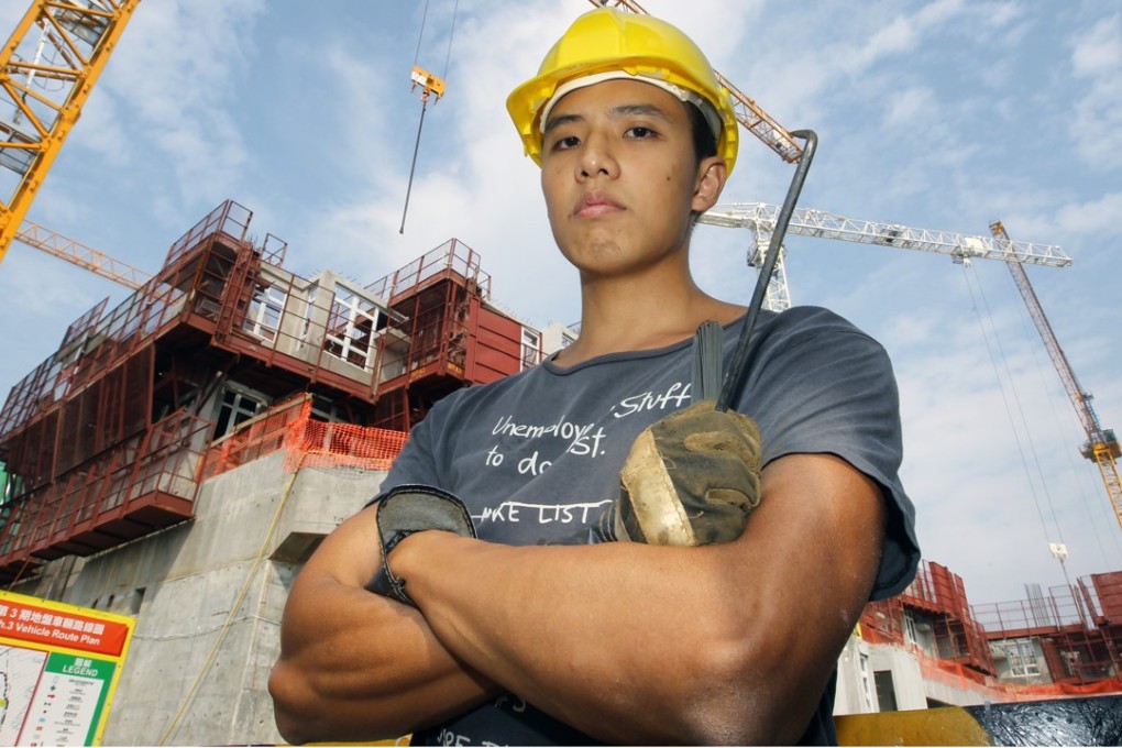 Yeung Wai-yip, an university graduate who became a bar-bender, poses for a photo at a construction site in Hung Shui Kiu. Hong Kong society has been accused of looking down on blue-collar labourers, even though the city needs them and they can make more money than some university graduates. Photo: Edward Wong