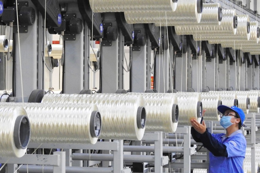 An employee works on a carbon fibre production line at a factory in Lianyungang, in China’s eastern Jiangsu province, on August 9. China’s PMI fell in August, setting alarm bells ringing in the manufacturing sector. Photo: AFP