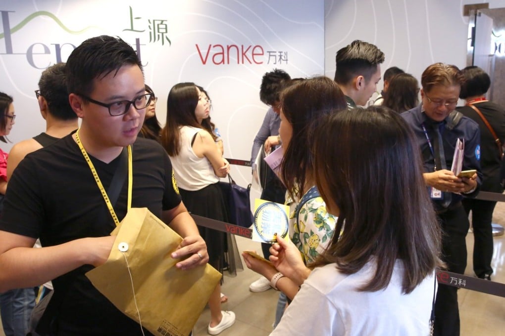 Prospective investors queue up for Vanke Property (Hong Kong)’s Le Pont project in Tuen Mun, where 347 flats were on sale, on Sunday. Photo: Edmond So