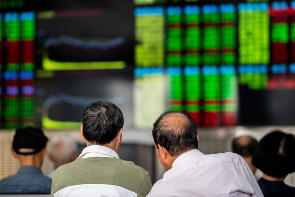 Investors monitor stock prices at a securities company in Shanghai on September 25. Despite an inflow of foreign cash, thanks to recent listings of Chinese stocks on key emerging market equity indices, mainland investors have shown scepticism about the state of the Chinese economy. Photo: AFP