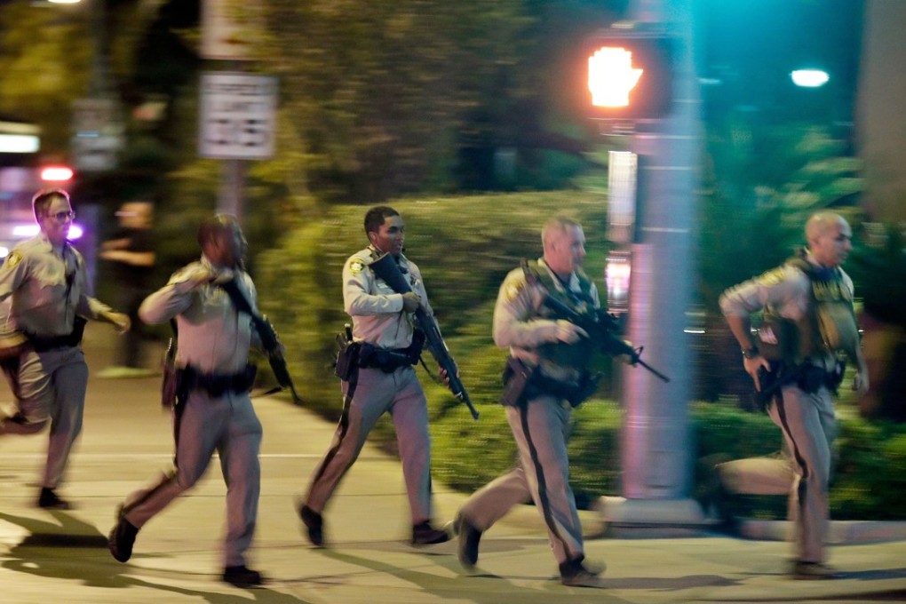 Police run toward the scene of a shooting near the Mandalay Bay resort and casino on the Las Vegas Strip in Las Vegas on October 1, 2017. Photo: AP