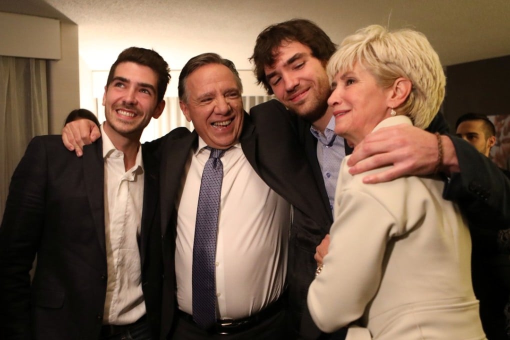 Coalition Avenir Quebec (CAQ) party leader Francois Legault, his wife Isabelle Brais and sons Victor (L) and Xavier celebrate. Photo: Reuters