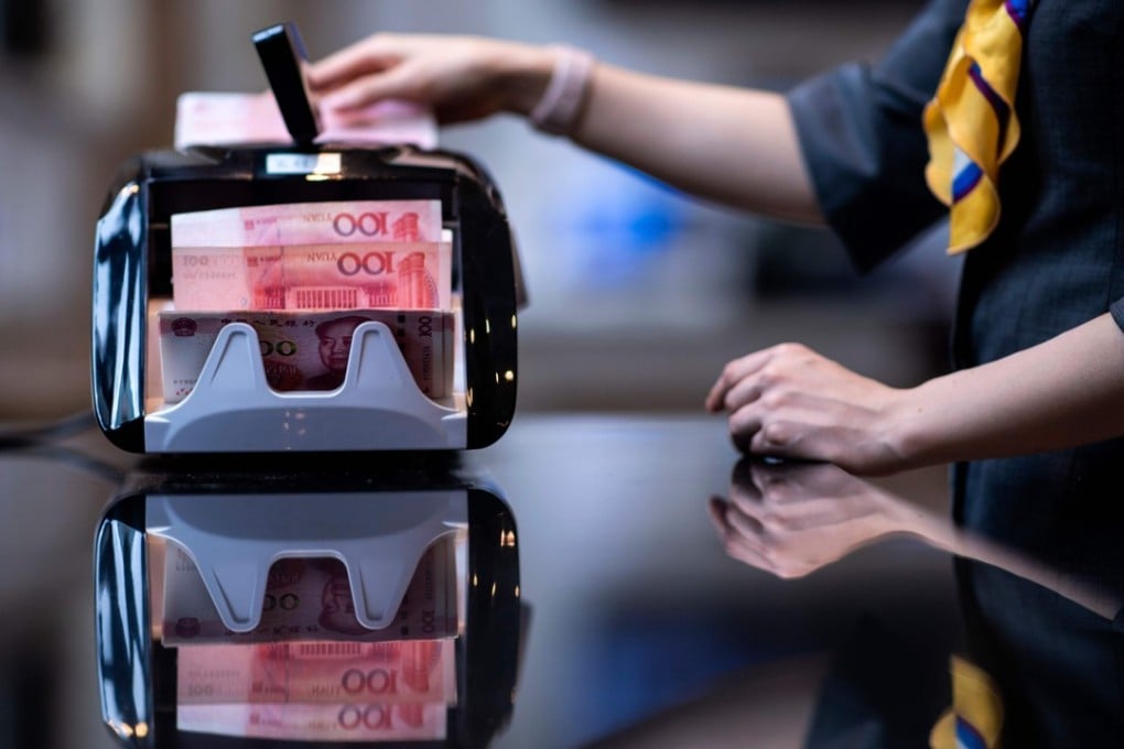 Counting out 100 yuan (US$14.6) notes at a bank in Shanghai. It has started appealing more as a reserve currency after the Chinese central bank emphasised the need for its stability. Photo: AFP
