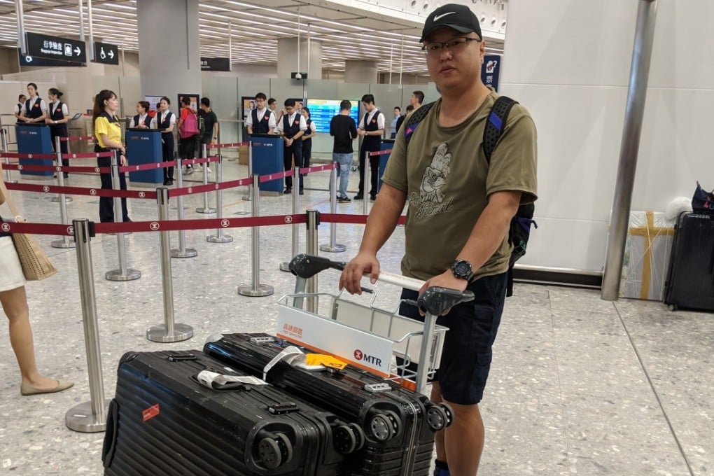 An express rail passenger is left clearly displeased after not being allowed to bring his suitcases on board, at the West Kowloon terminus on September 23. Photo: SCMP