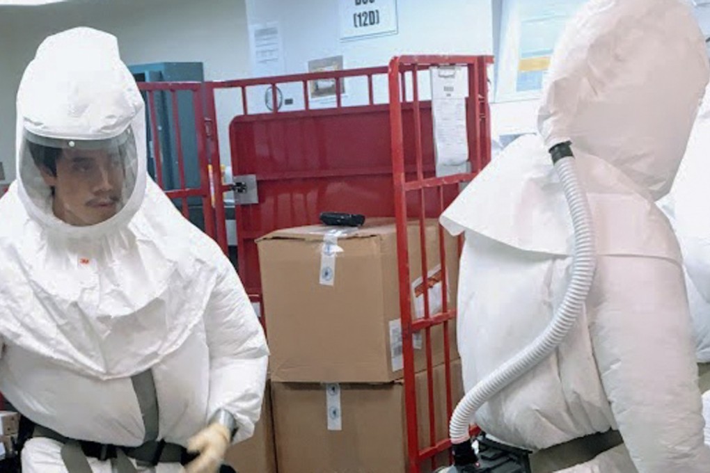 US Defence Department personnel, wearing protective suits, screen mail as it arrives at the Pentagon. Photo: AFP