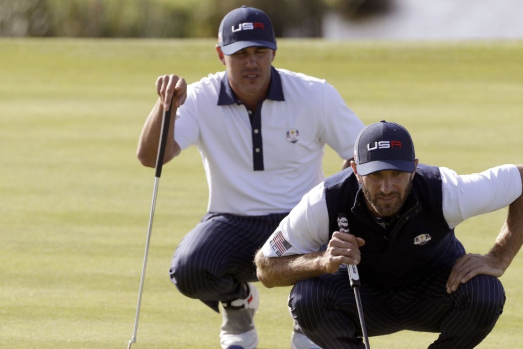 Dustin Johnson (right) and Brooks Koepka line up a putt during their foursomes match on the second day at Le Golf National. It was the only time they partnered each other. Photo: AFP